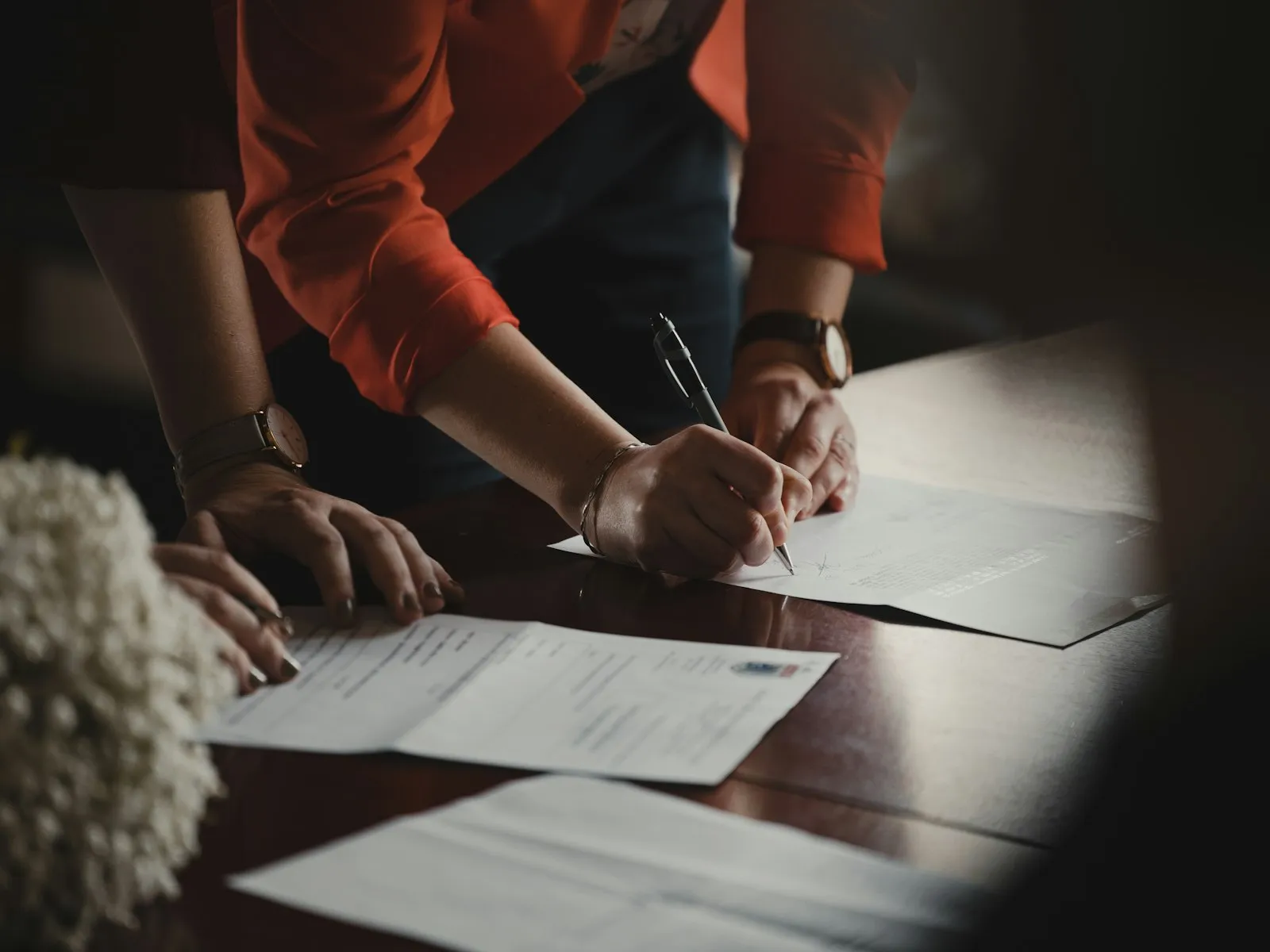 Someone working through paperwork at a table.